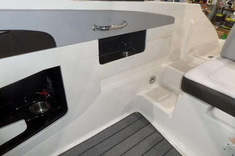 Slide: The Image of Interior view of a 2017 Sea Ray SDX 240 boat, featuring seating and storage compartments. - 20