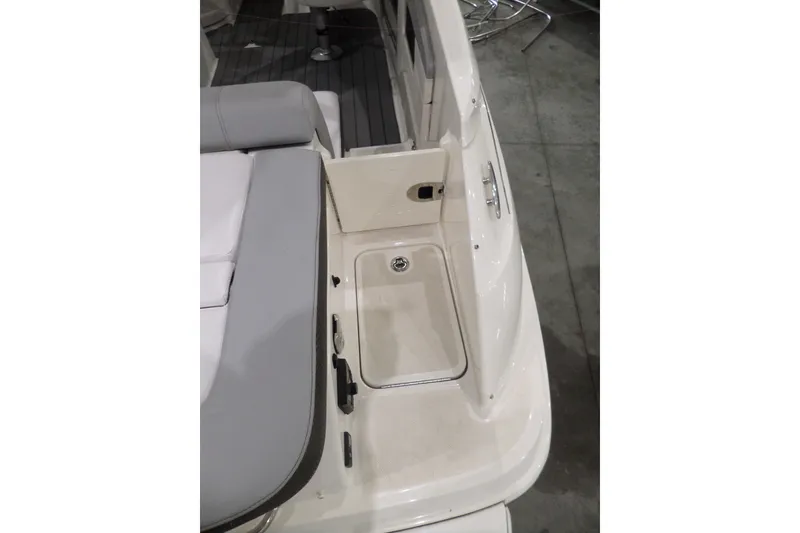Slide: The Image of 2017 Sea Ray SDX 240 boat interior with seating and storage compartment. - 14