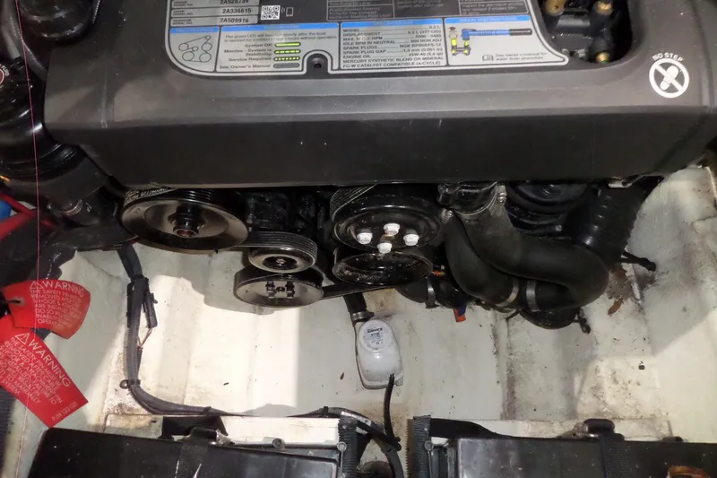 Slide: The Image of Engine compartment of a 2017 Sea Ray SDX 240 boat, showing belts and hoses. - 49