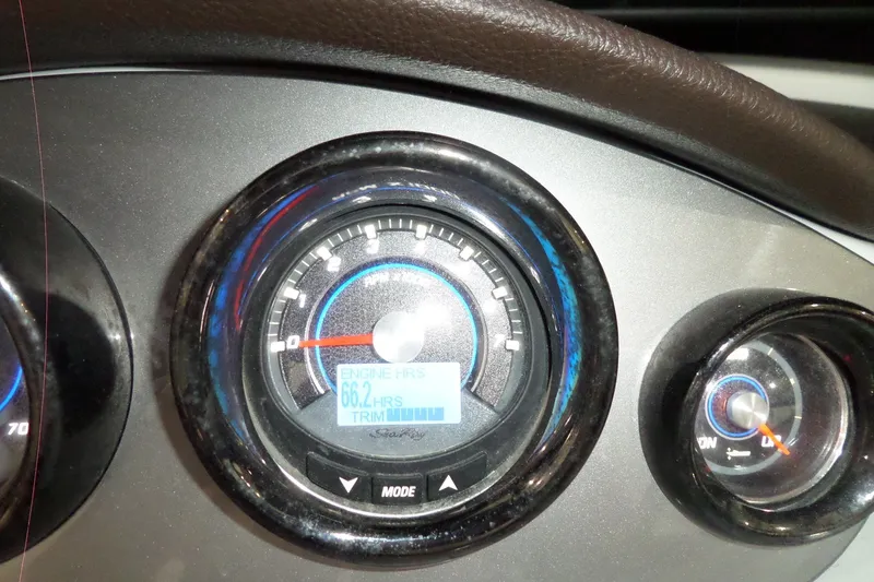 Slide: The Image of Dashboard of a 2017 Sea Ray SDX 240 showing engine hours and trim gauge. - 35