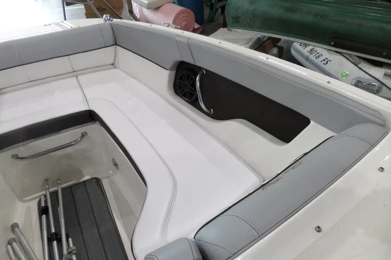 Slide: The Image of 2017 Sea Ray SDX 240 boat interior with white seating and storage compartment. - 36