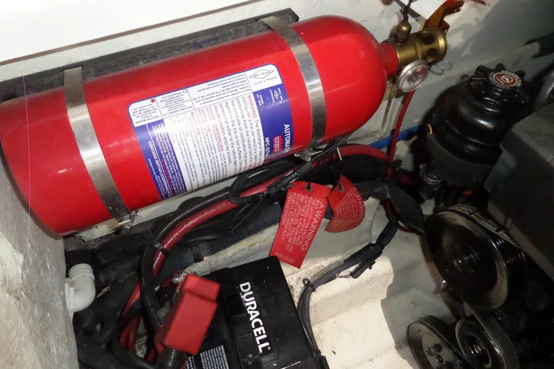 Slide: The Image of Engine compartment of 2017 Sea Ray SDX 240 with fire extinguisher and battery. - 50
