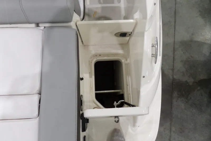 Slide: The Image of 2017 Sea Ray SDX 240 boat storage compartment with open hatch and seating area. - 15