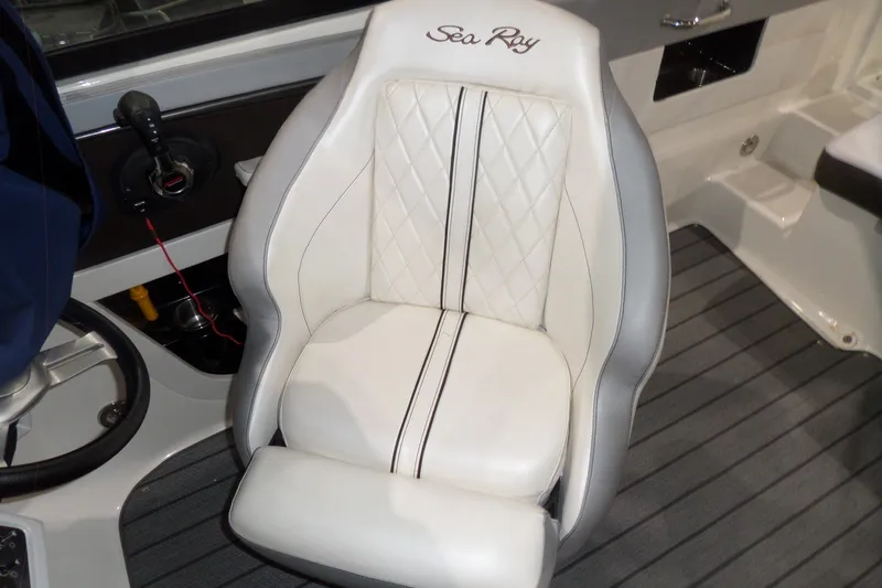 Slide: The Image of Captain's seat on a 2017 Sea Ray SDX 240 boat, featuring white upholstery and elegant design. - 55
