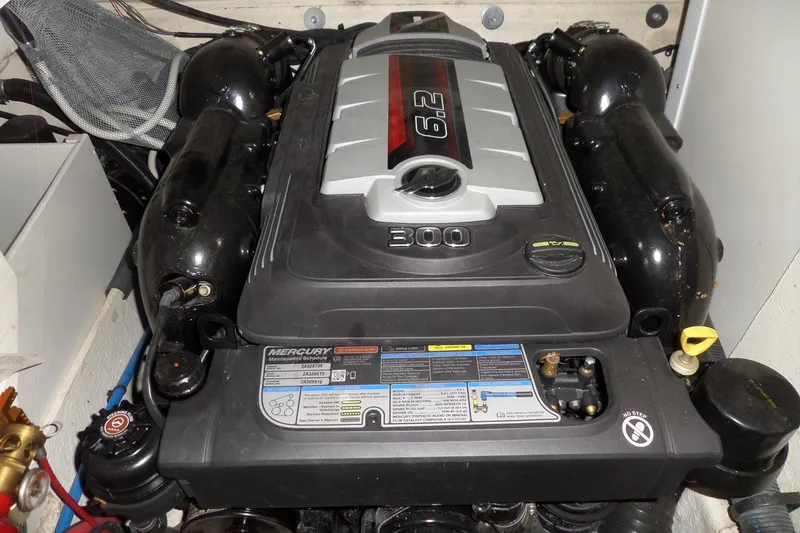 Slide: The Image of Engine compartment of a 2017 Sea Ray SDX 240 boat, featuring a Mercury 6.2L engine. - 48