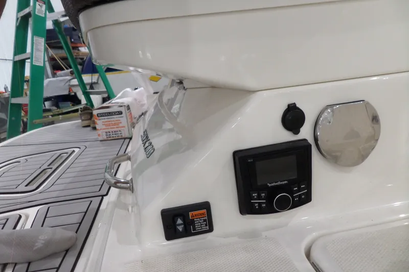 Slide: The Image of 2017 Sea Ray SDX 240 boat dashboard with audio controls and deck details. - 16