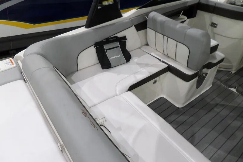 Slide: The Image of 2017 Sea Ray SDX 240 boat interior with gray seating and a branded bag. - 17