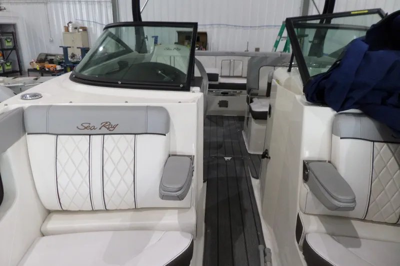 Slide: The Image of 2017 Sea Ray SDX 240 boat interior with white and gray seating in a storage facility. - 43