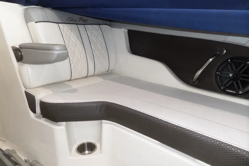 Slide: The Image of Interior seating of a 2017 Sea Ray SDX 240 boat, featuring white and black upholstery. - 44