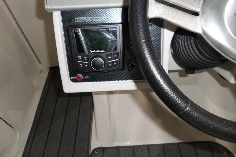Slide: The Image of Steering wheel and control panel of 2017 Sea Ray SDX 240 boat. - 30