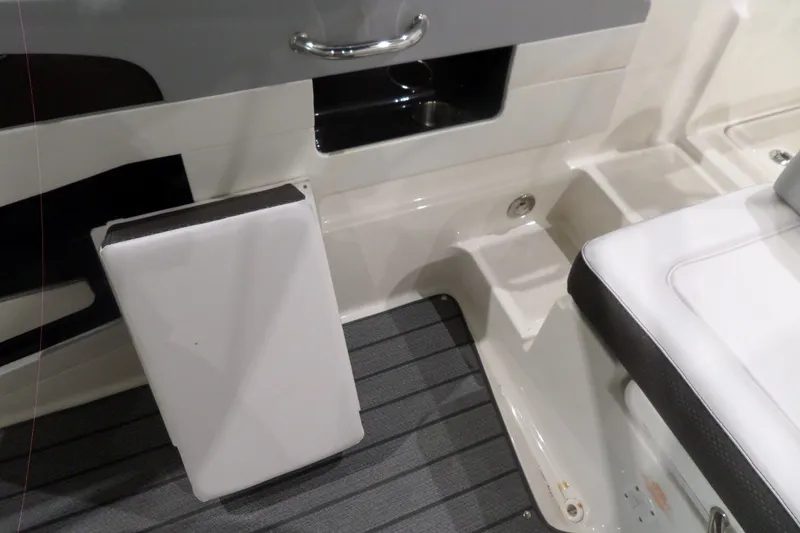 Slide: The Image of Interior view of a 2017 Sea Ray SDX 240 boat, featuring seating and storage compartments. - 46
