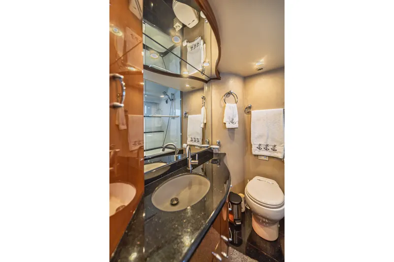Slide: The Image of Luxurious 2004 Marquis 59 yacht bathroom with elegant fixtures and mirrored cabinetry. - 71