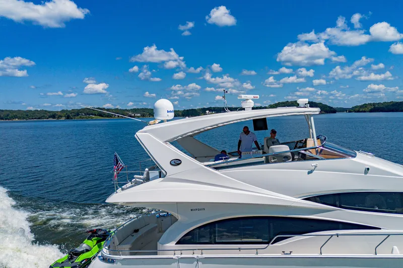 Slide: The Image of Luxury 2004 Marquis 59 yacht cruising on a sunny day with clear blue skies. - 8