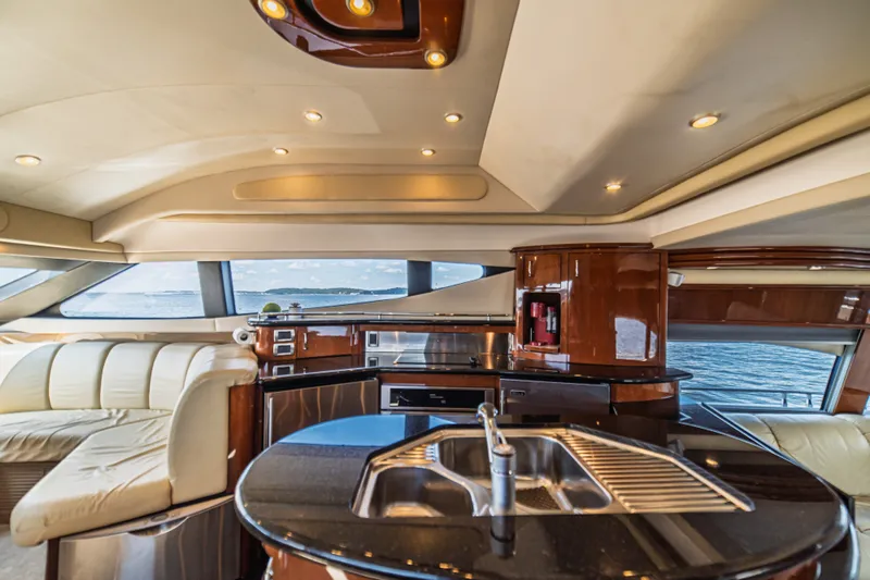 Slide: The Image of Luxurious interior of a 2004 Marquis 59 yacht with modern kitchen and seating area. - 49