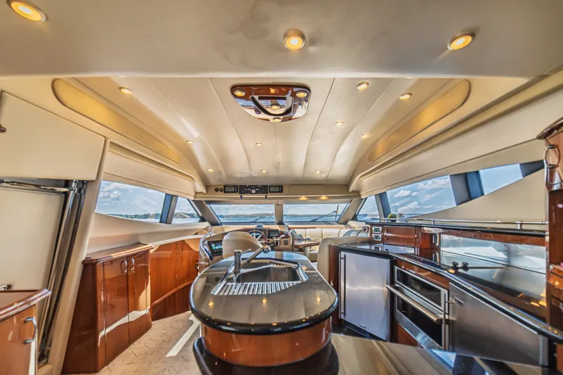 Slide: The Image of Luxurious interior of a 2004 Marquis 59 yacht with modern kitchen and panoramic windows. - 48