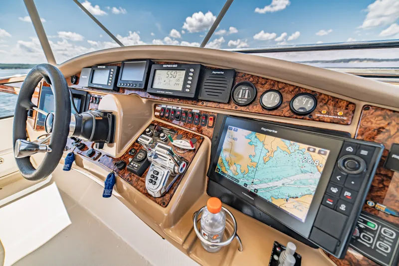 Slide: The Image of Cockpit of 2004 Marquis 59 yacht with navigation equipment and steering wheel. - 26