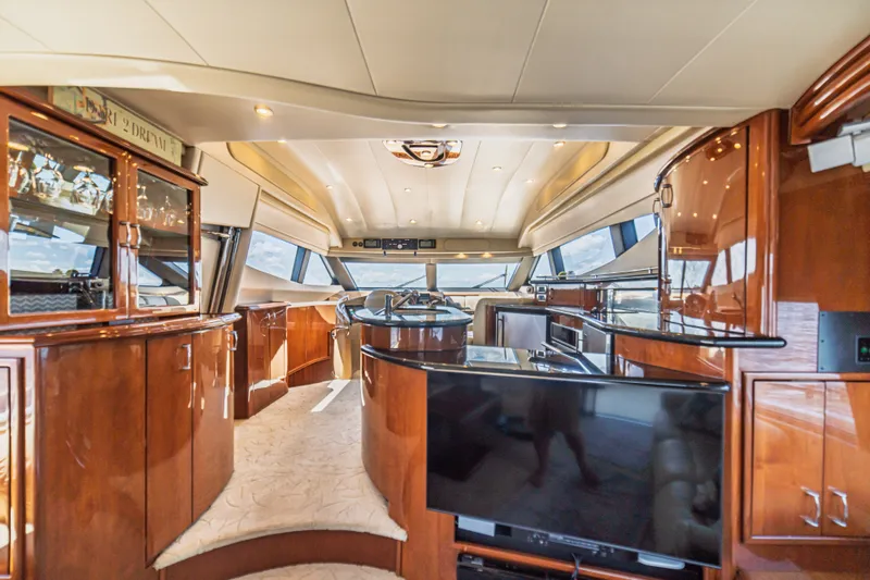 Slide: The Image of Luxurious interior of a 2004 Marquis 59 yacht with polished wood finishes and modern amenities. - 43