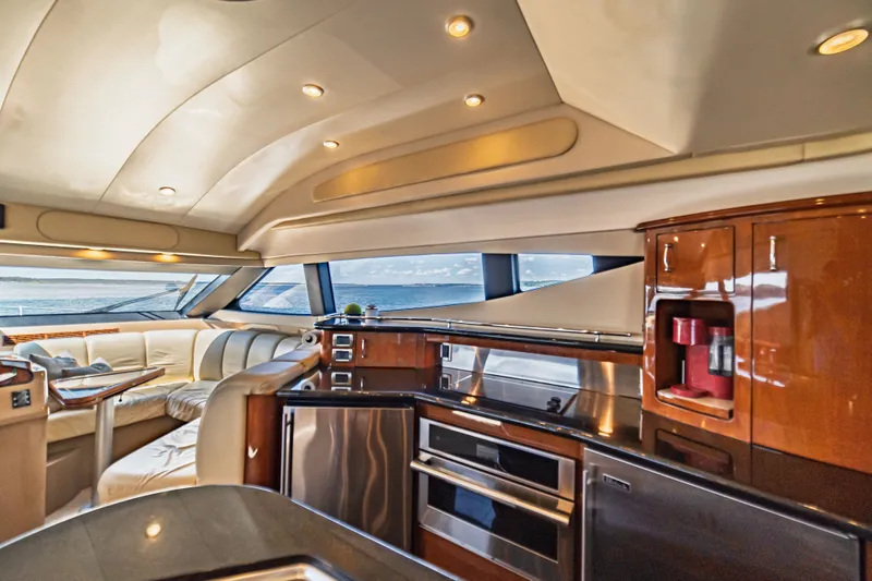 Slide: The Image of Luxurious interior of a 2004 Marquis 59 yacht with modern kitchen and seating area. - 45