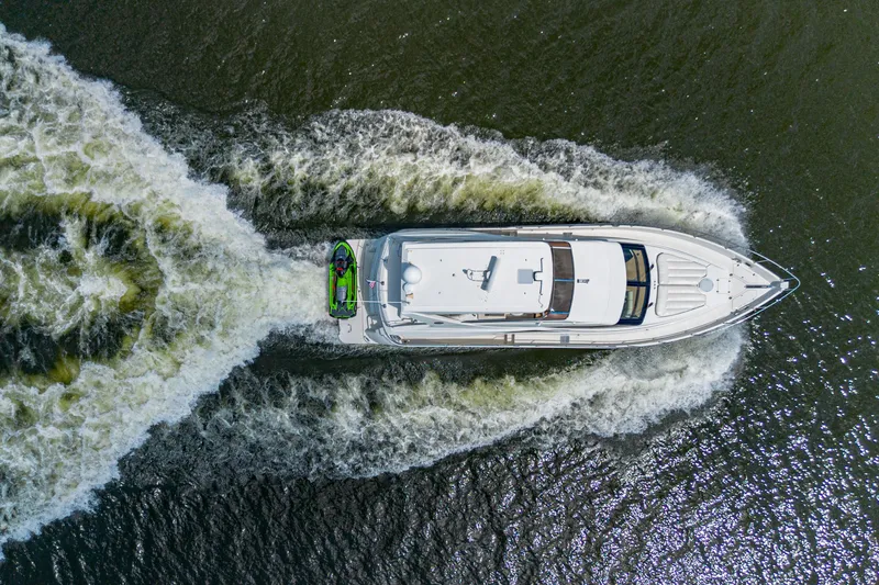 Slide: The Image of Aerial view of 2004 Marquis 59 yacht cruising on water with visible wake. - 6