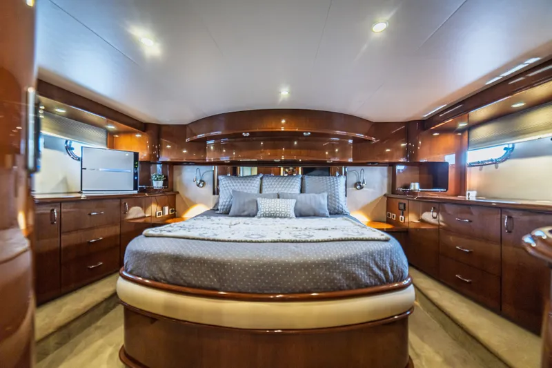 Slide: The Image of Luxurious 2004 Marquis 59 yacht bedroom with elegant wood finishes and modern amenities. - 65