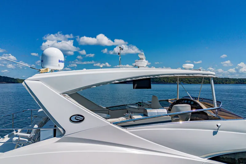 Slide: The Image of Luxury 2004 Marquis 59 yacht on serene water under clear blue sky. - 18
