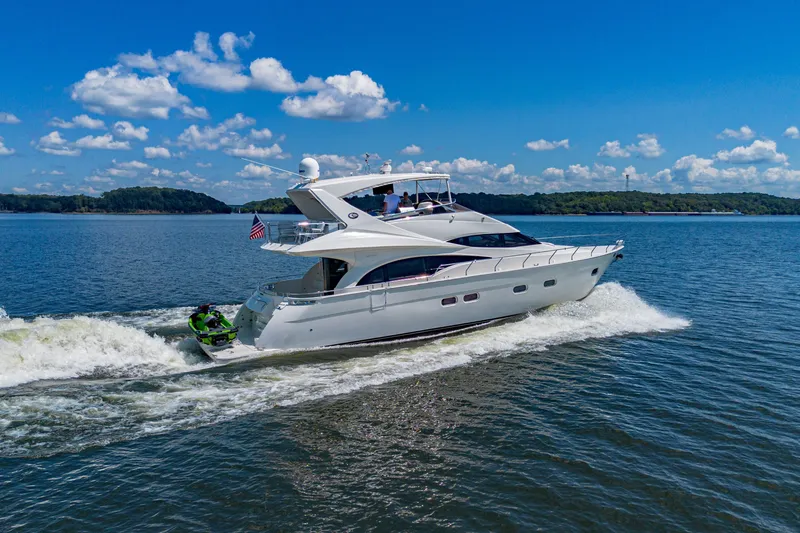 Slide: The Image of Luxury 2004 Marquis 59 yacht cruising on a sunny day with clear blue skies. - 7