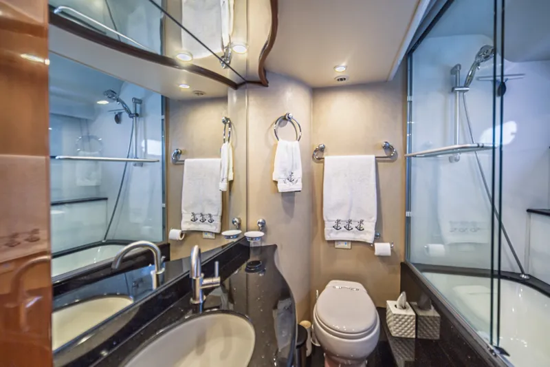 Slide: The Image of Luxurious 2004 Marquis 59 yacht bathroom with elegant fixtures and glass shower enclosure. - 70