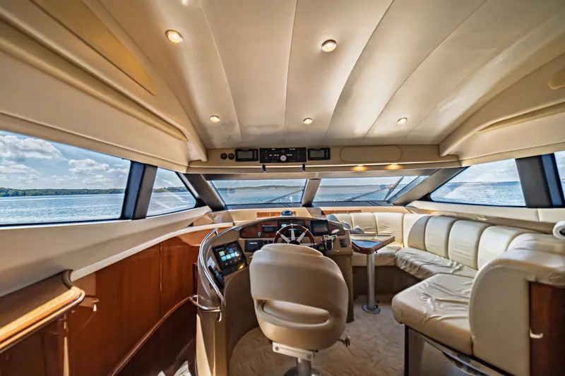 Slide: The Image of Luxurious interior of a 2004 Marquis 59 yacht with panoramic windows and plush seating. - 56