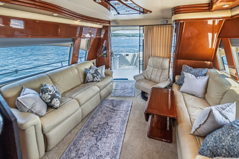 Slide: The Image of Luxurious interior of a 2004 Marquis 59 yacht with elegant seating and scenic ocean view. - 37