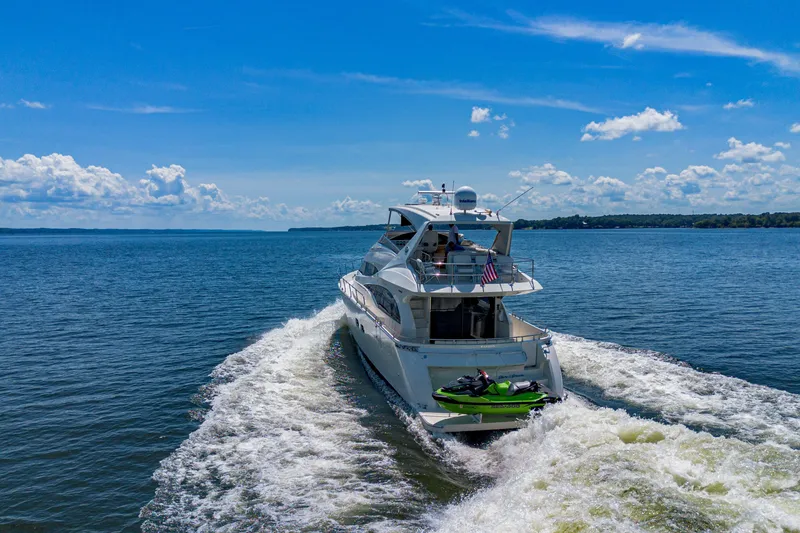 Slide: The Image of Luxury 2004 Marquis 59 yacht cruising on a sunny day with clear blue skies. - 15