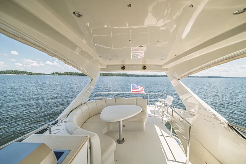 Slide: The Image of Luxurious 2004 Marquis 59 yacht interior with seating, table, and scenic water view. - 32