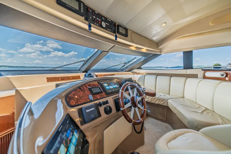 Slide: The Image of Luxurious interior of a 2004 Marquis 59 yacht with panoramic views and elegant seating. - 58