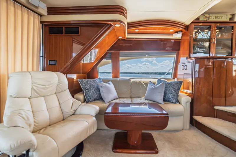 Slide: The Image of Luxurious interior of a 2004 Marquis 59 yacht with plush seating and elegant wood finishes. - 41