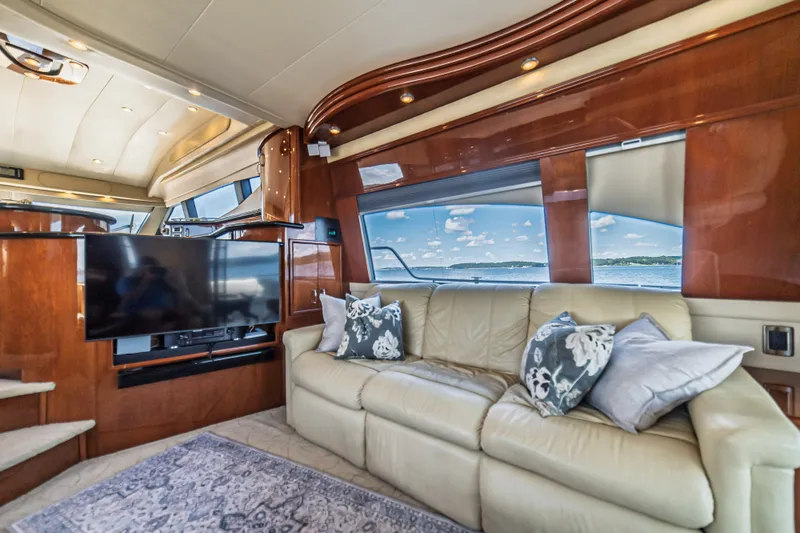 Slide: The Image of Luxurious 2004 Marquis 59 yacht interior with leather sofa, TV, and scenic window view. - 38