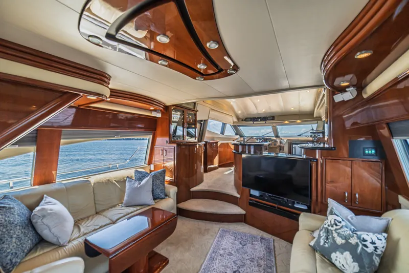 Slide: The Image of Luxurious interior of a 2004 Marquis 59 yacht with elegant wood finishes and plush seating. - 40