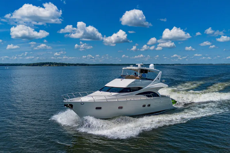 Slide: The Image of Luxury 2004 Marquis 59 yacht cruising on a sunny day with blue skies. - 13