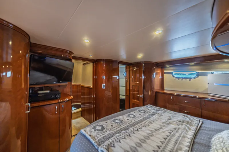 Slide: The Image of Luxurious 2004 Marquis 59 yacht interior with polished wood, cozy bed, and modern amenities. - 67