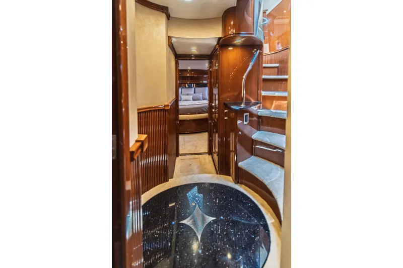 Slide: The Image of Luxurious interior of 2004 Marquis 59 yacht with elegant wood finishes and spiral staircase. - 64