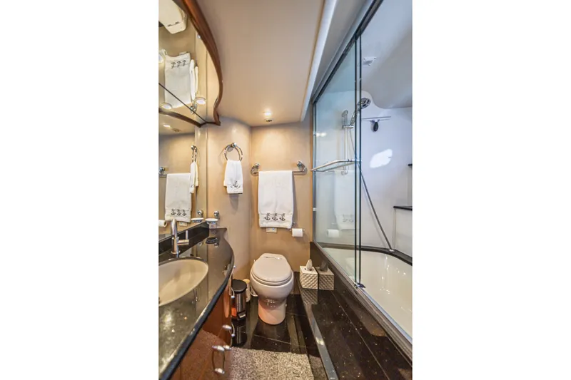 Slide: The Image of Luxurious bathroom in a 2004 Marquis 59 yacht with modern fixtures and elegant design. - 72