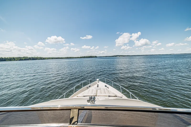 Slide: The Image of Bow view from a 2004 Marquis 59 yacht on a sunny day at sea. - 29