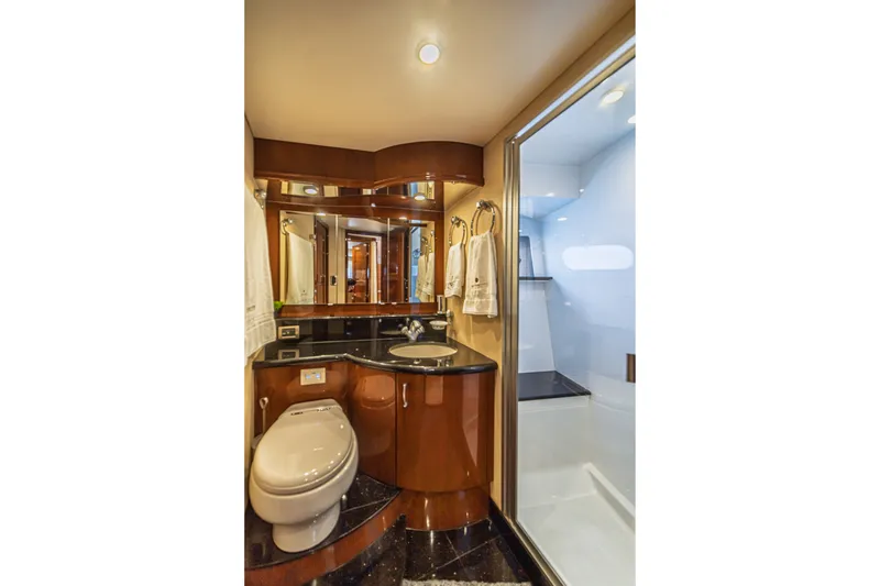 Slide: The Image of Luxurious 2004 Marquis 59 yacht bathroom with elegant wood cabinetry and modern fixtures. - 61