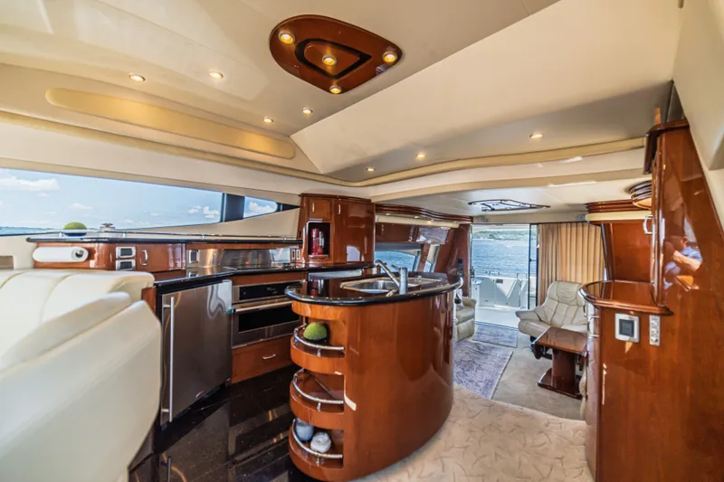Slide: The Image of Luxurious interior of a 2004 Marquis 59 yacht with elegant wood finishes and modern amenities. - 36