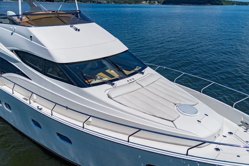 Slide: The Image of Luxurious 2004 Marquis 59 yacht cruising on serene blue waters. - 20