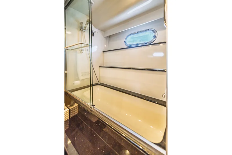 Slide: The Image of Luxurious 2004 Marquis 59 yacht bathroom with glass shower and porthole window. - 69