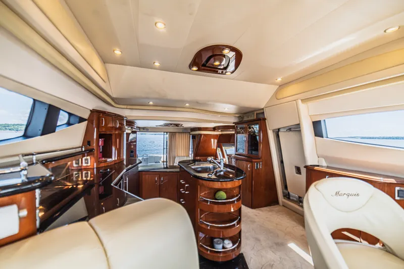 Slide: The Image of Luxurious interior of a 2004 Marquis 59 yacht with elegant wood finishes and modern amenities. - 50