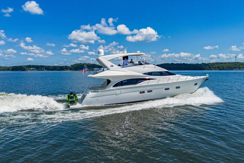The Image of 2004 Marquis 59 yacht cruising on a sunny day with clear blue skies. - 1