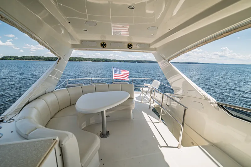 Slide: The Image of Luxurious 2004 Marquis 59 yacht interior with seating, table, and ocean view. - 30