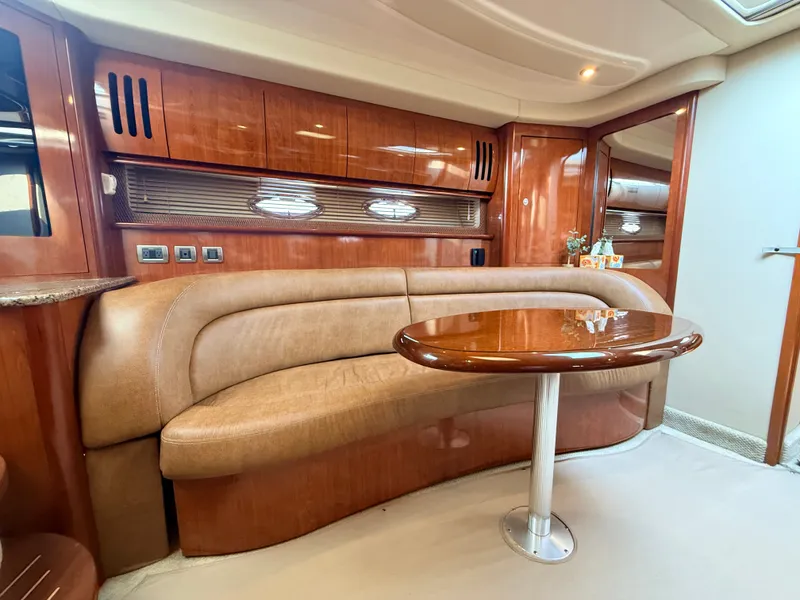 Slide: The Image of Interior of the 2005 Sea Ray 420 Sundancer with elegant wood paneling and beige sofa. - 21