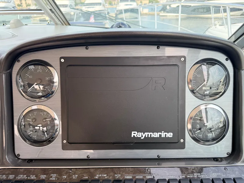 Slide: The Image of Dashboard of a 2005 Sea Ray 420 Sundancer with Raymarine screen and gauges. - 16