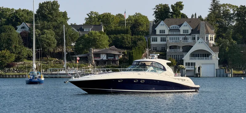 The Image of A 2005 Sea Ray 420 Sundancer on calm waters with elegant houses in the background. - 0